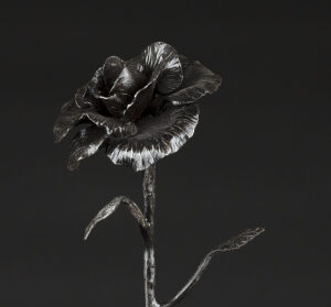 Forged rose standing in wood